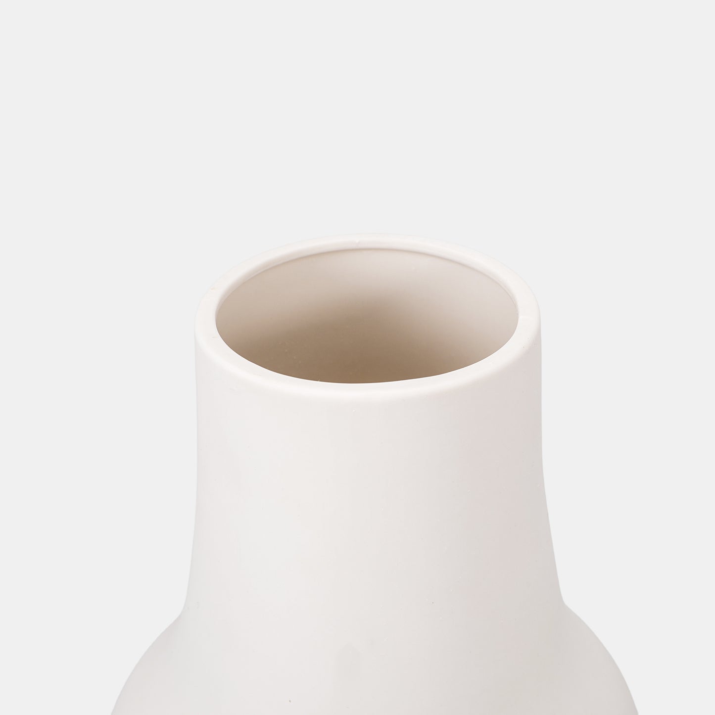 Crafted for understated luxury, this white ceramic vase features a tapered silhouette. Perfect for flowers on vase displays or clustered bud vases. The small vase’s frosted finish elevates eucalyptus stems and peony bouquets alike.