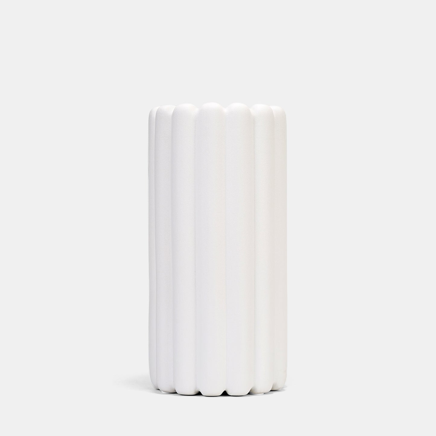 A tall vase blending organic ridges and Scandinavian minimalism. Its frosted white ceramic surface elevates pampas grass displays or fresh branches, while the floor vase design anchors rooms with quiet drama. Style alongside bud vases for layered texture.