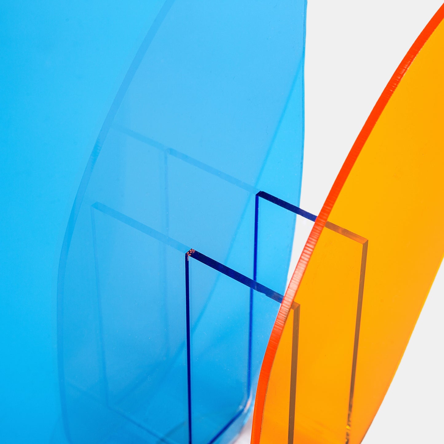Dynamic blue-orange small vase with water tight acrylic panels, abstract bud vase for vibrant artificial floral displays.Modern acrylic vase series for urban living. The clear vase set includes 4 miniature vases (5" tall) with distortion-free walls. Each acrylic mini vase holds fresh or faux stems, while the small vase format suits studio apartments.