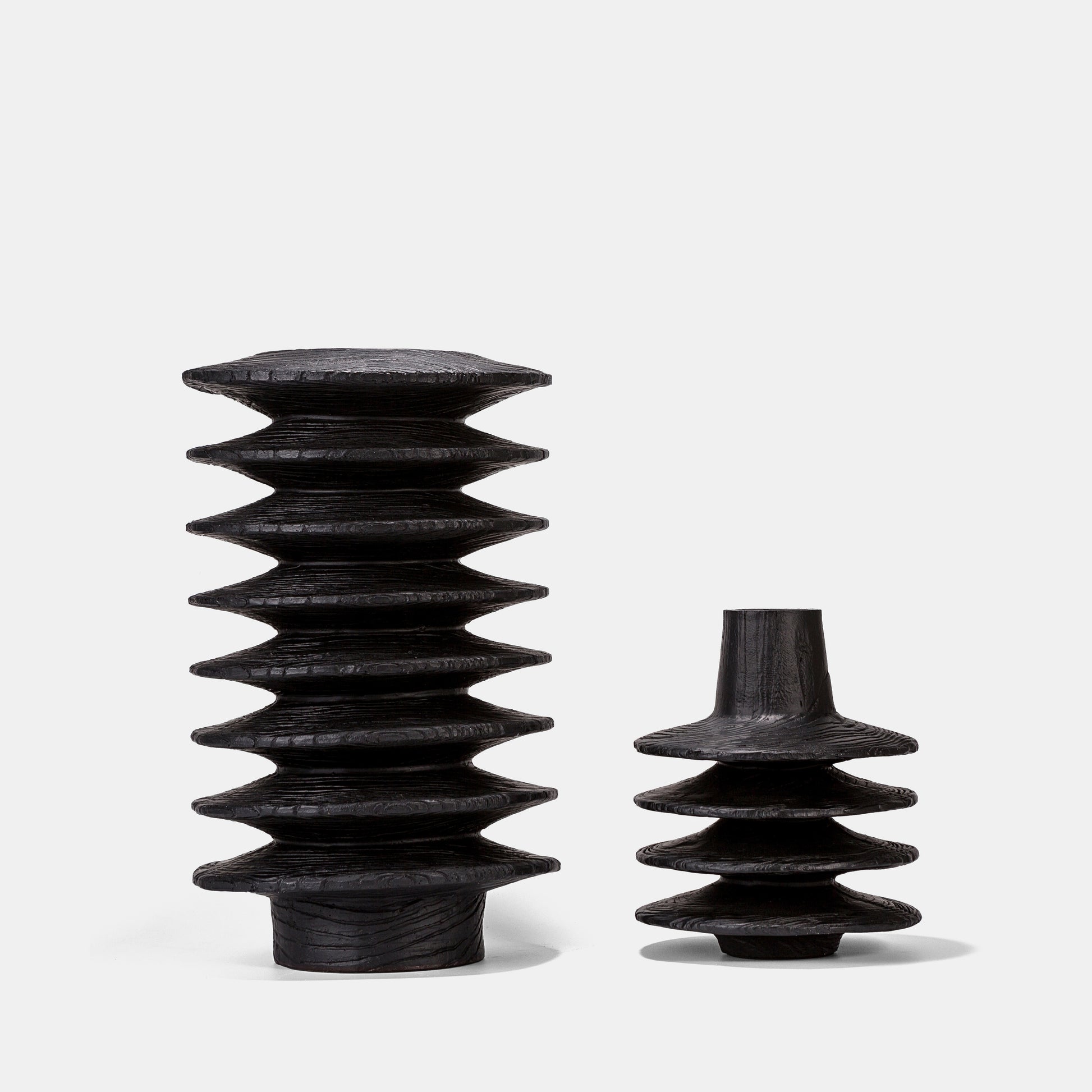 Sleek black large vase with organic woodgrain texture anchors any space, paired with sculptural floor vases and delicate bud vases. This cheap vase collection in durable resin offers budget-friendly sophistication for modern interiors.