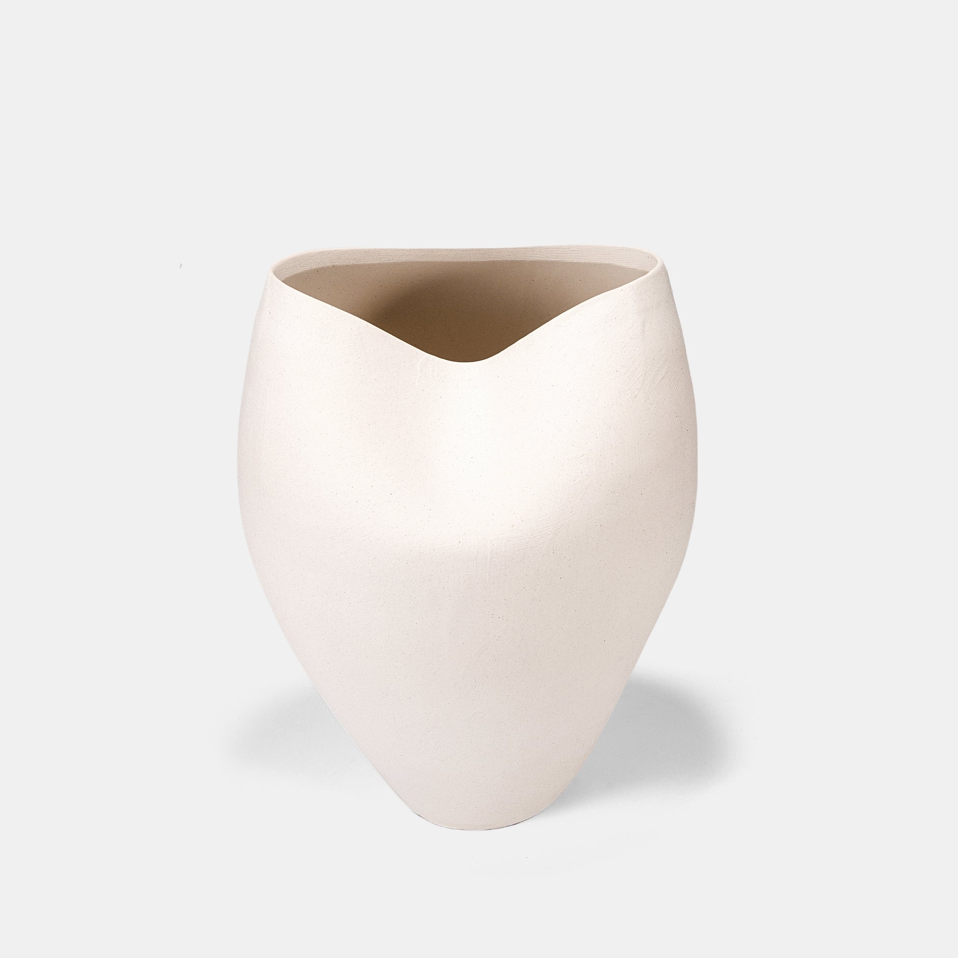 This white ceramic vase channels seaside serenity through its wave-mimicking form. Use as a tall vase for dramatic hydrangeas or a minimalist floor vase. Cluster bud vases at its base for organic contrast.