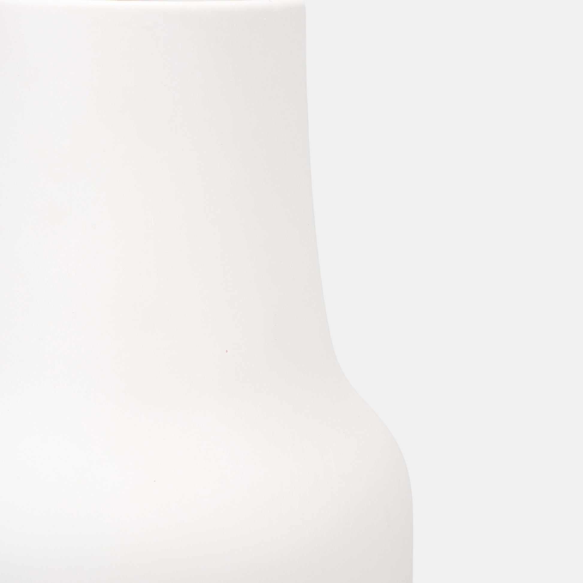 A sleek ceramic vase designed for dual roles: showcase vibrant flowers on vase or let its sculptural form stand solo. The small vase’s smooth white surface contrasts beautifully with textured bud vases. Neutral and timeless for evolving decor styles.
