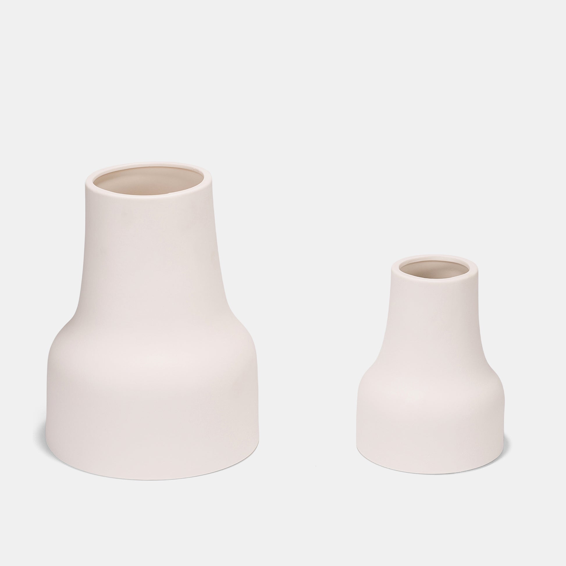 Versatile ceramic vase with a clean, matte white design. Use it as a small vase for fresh blooms, dried grasses, or alongside bud vases for dynamic depth. Its neutral tone makes flowers on vase arrangements pop effortlessly.