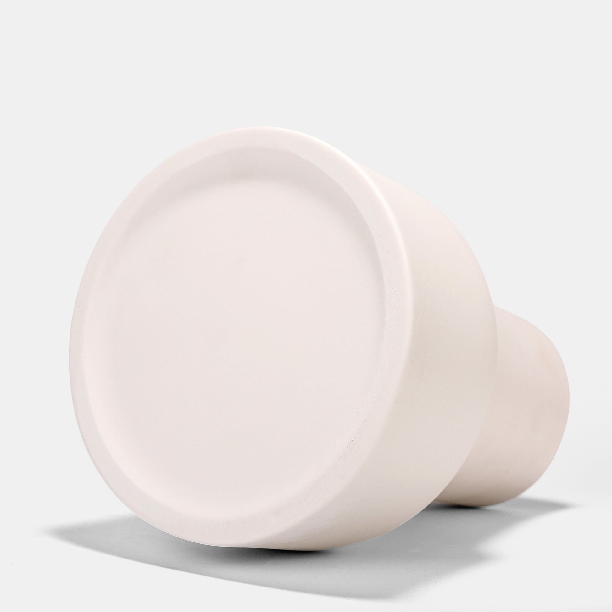 This tapered white ceramic vase merges minimalist elegance with functional versatility. Its matte frosted finish highlights flowers on vase arrangements, from roses to dried botanicals. Pair with petite bud vases for layered tablescapes. Compact yet bold, this small vase adapts to modern or rustic interiors. 