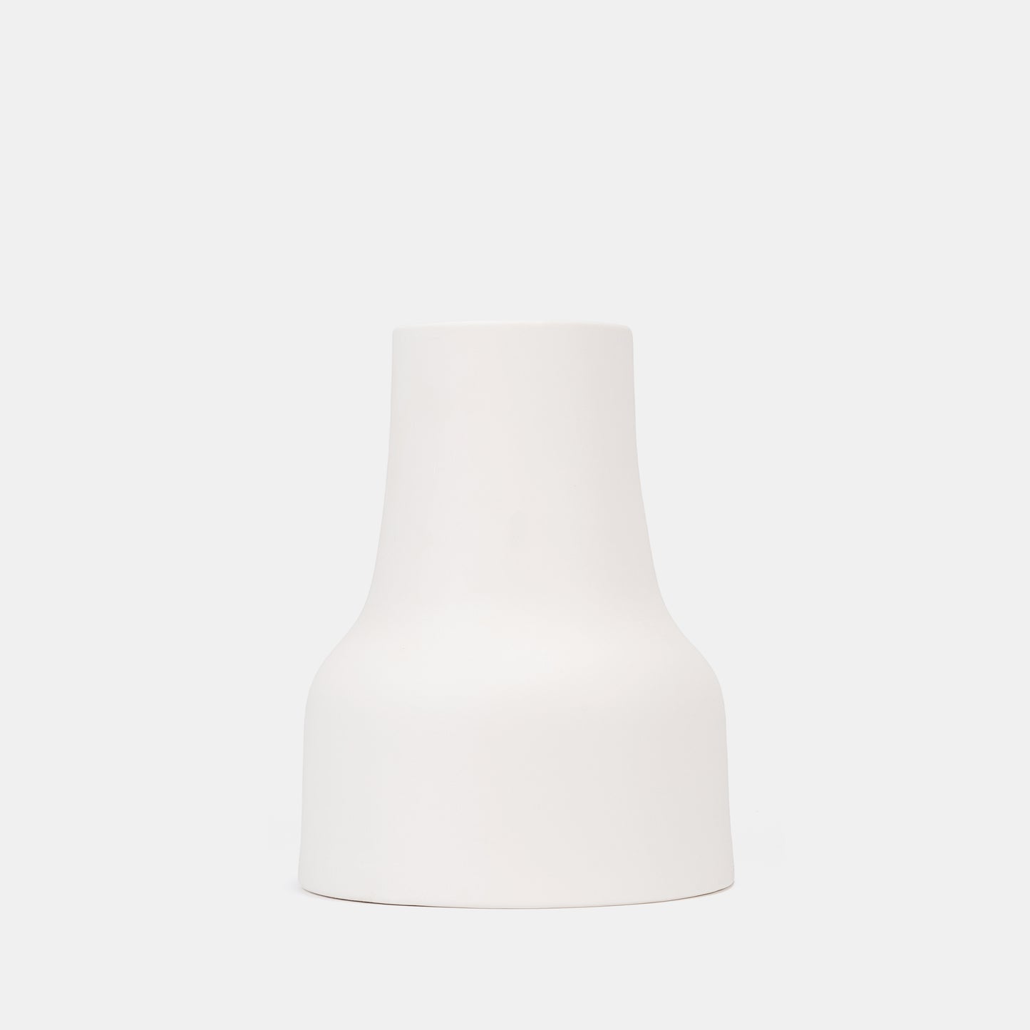 Elevate shelves or tables with this tapered white ceramic vase. The small vase’s minimalist profile pairs seamlessly with bud vases, while its bright white surface amplifies flowers on vase artistry. Ideal for compact, chic spaces. 