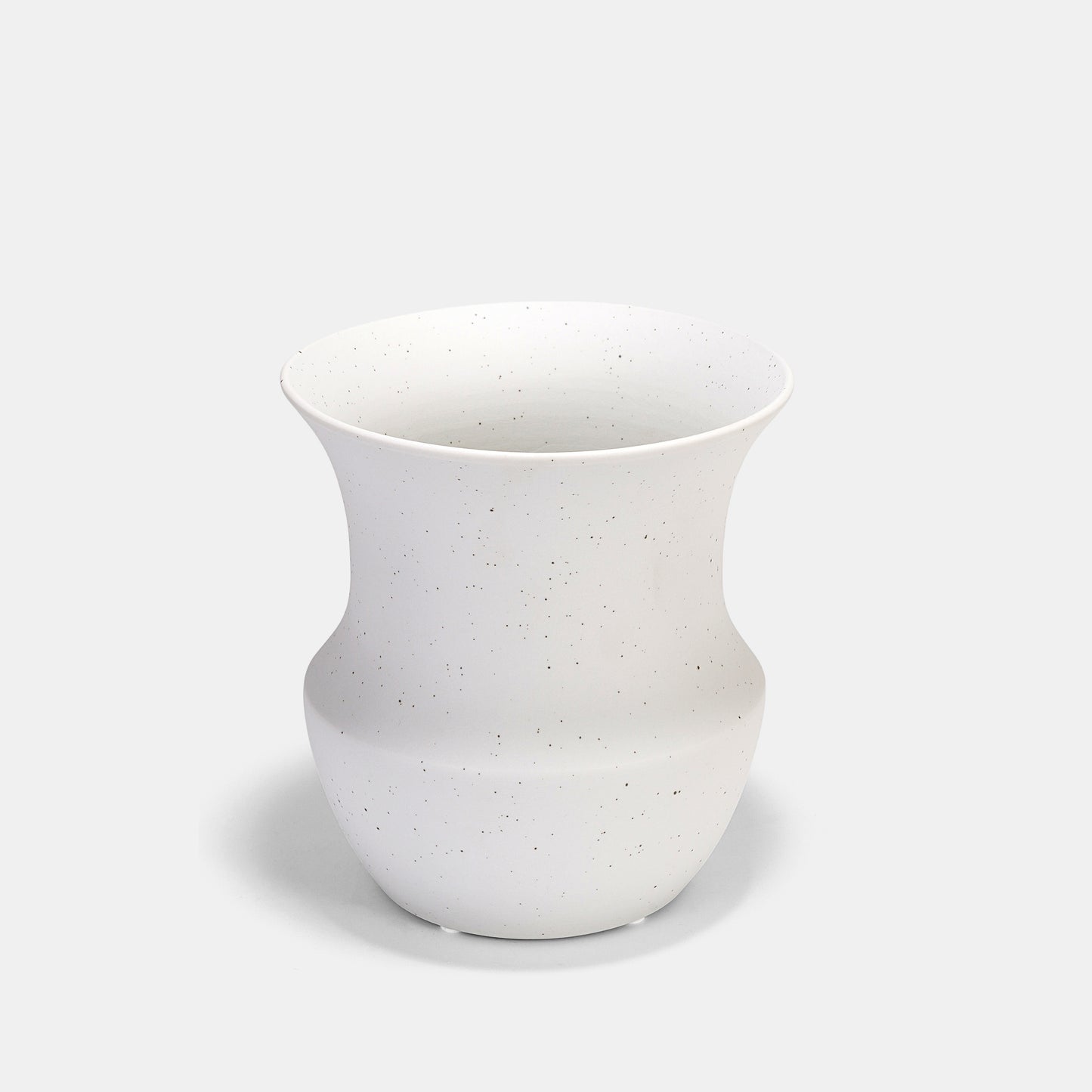 A timeless white color vase where artful imperfections meet refined design. The speckled ceramic vase evolves with subtle tonal variations, perfect for ivy trails or peony bouquets. Style alongside bud vases to bridge modern and rustic aesthetics effortlessly. 