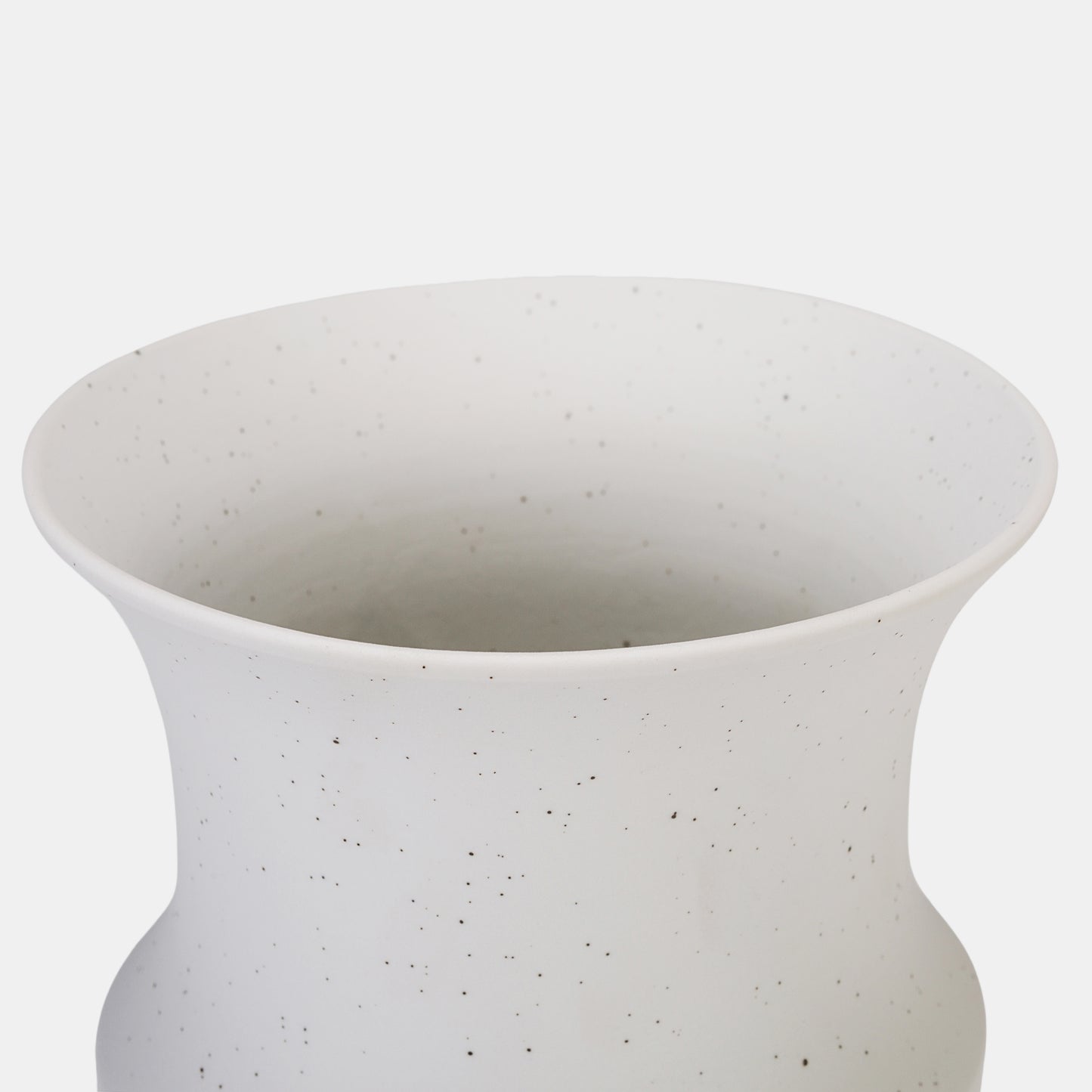 This ceramic vase charms with its organic speckled pattern and balanced curves, blending rustic warmth with modern minimalism. The white color vase’s matte finish gracefully highlights flowers on vase arrangements, from fresh blooms to dried botanicals. Pair with petite bud vases for layered texture in farmhouse or contemporary spaces. 