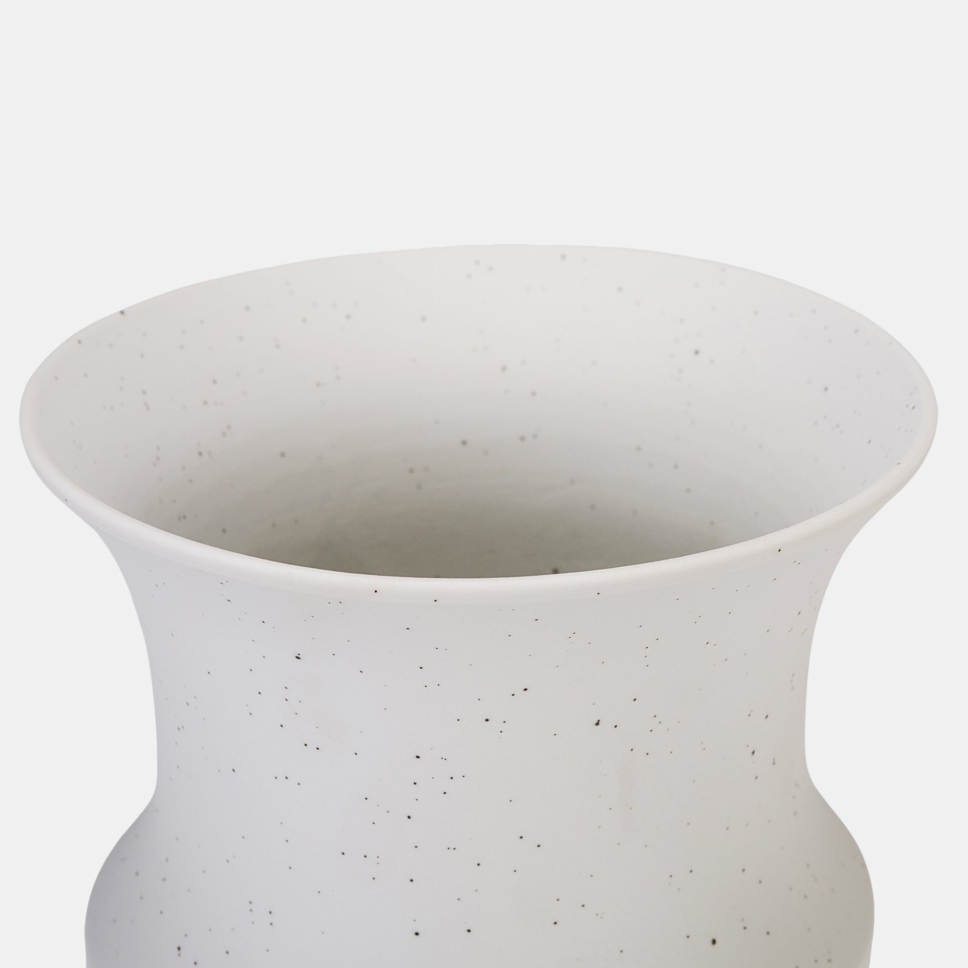 This ceramic vase charms with its organic speckled pattern and balanced curves, blending rustic warmth with modern minimalism. The white color vase’s matte finish gracefully highlights flowers on vase arrangements, from fresh blooms to dried botanicals. Pair with petite bud vases for layered texture in farmhouse or contemporary spaces. 