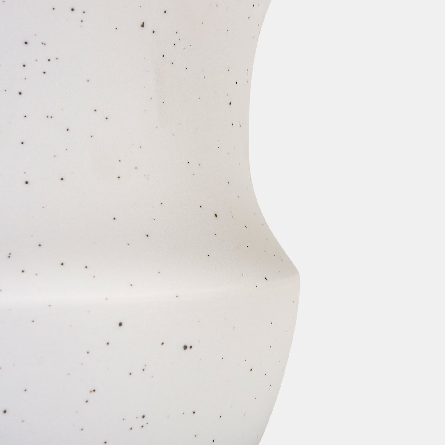 Elevate spaces with a white ceramic vase that celebrates organic elegance. The speckled finish and curved silhouette enhance flowers on vase displays, while pairing with bud vases adds curated charm. Durable and nostalgic, it anchors modern farmhouse or minimalist styles. 