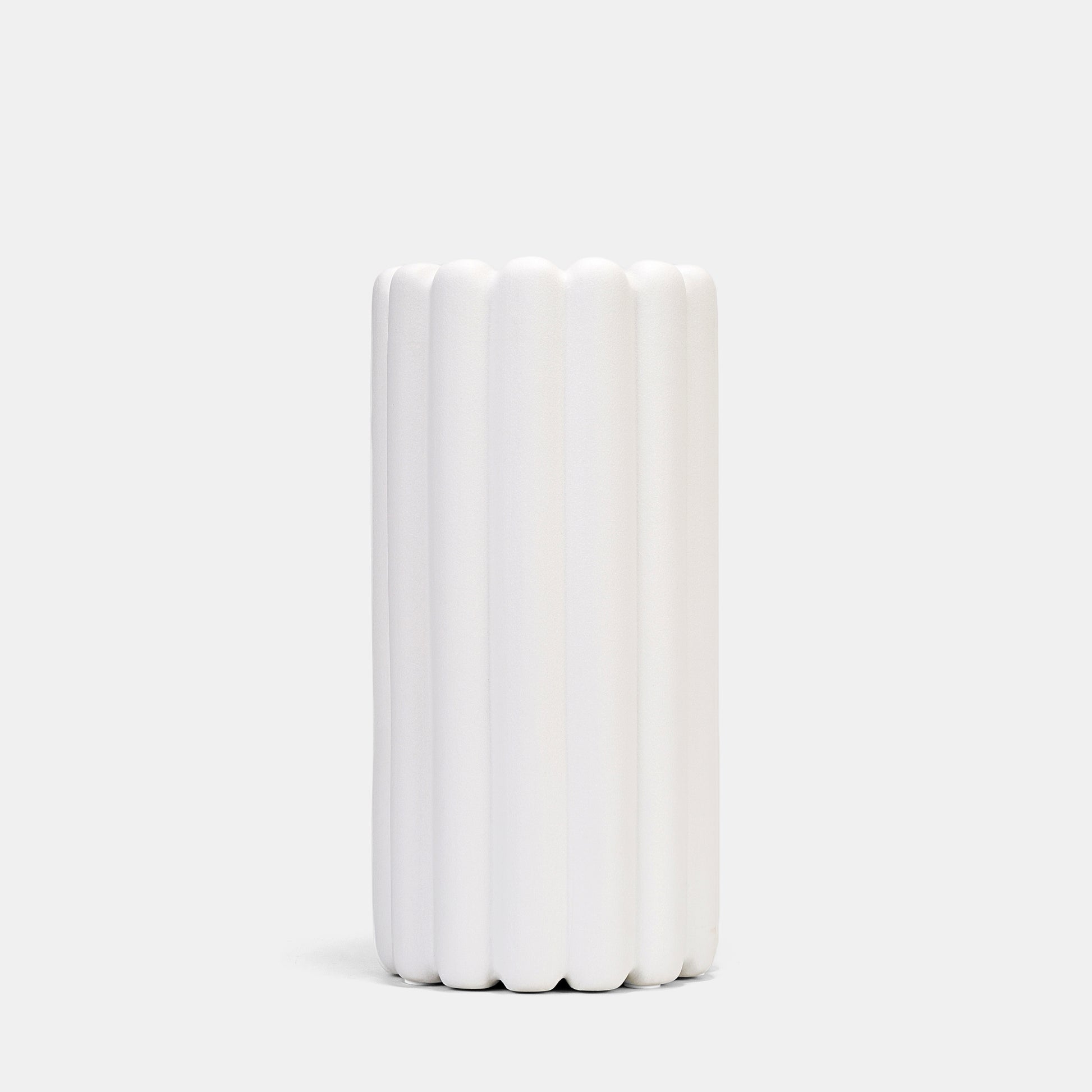 A tall vase blending organic ridges and Scandinavian minimalism. Its frosted white ceramic surface elevates pampas grass displays or fresh branches, while the floor vase design anchors rooms with quiet drama. Style alongside bud vases for layered texture. 