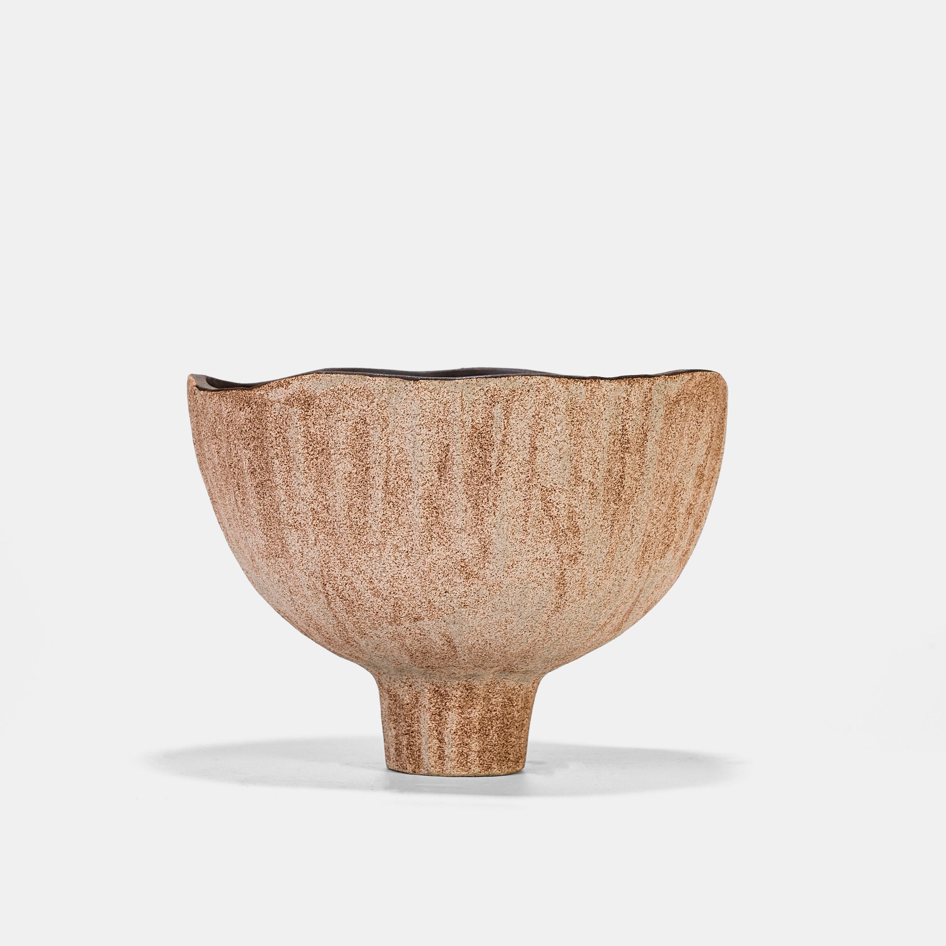 This ceramic vase blends desert-inspired textures with an inverted trumpet shape, perfect for showcasing flowers on vase arrangements or air plants. Its 15.5cm compact design works as a small vase for tabletops or paired with bud vases for layered displays. The speckled finish adds rustic charm to floor vase setups in boho or modern spaces.