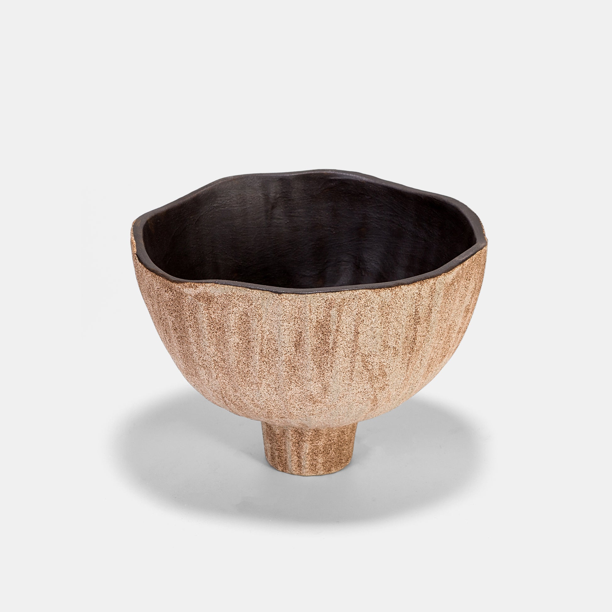 A versatile ceramic vase with a flared rim, ideal as a sculptural floor vase or petite small vase. Style it solo with dried stems, cluster with bud vases for texture, or highlight fresh flowers on vase. Earthy tones and organic form elevate minimalist and desert-modern interiors effortlessly.