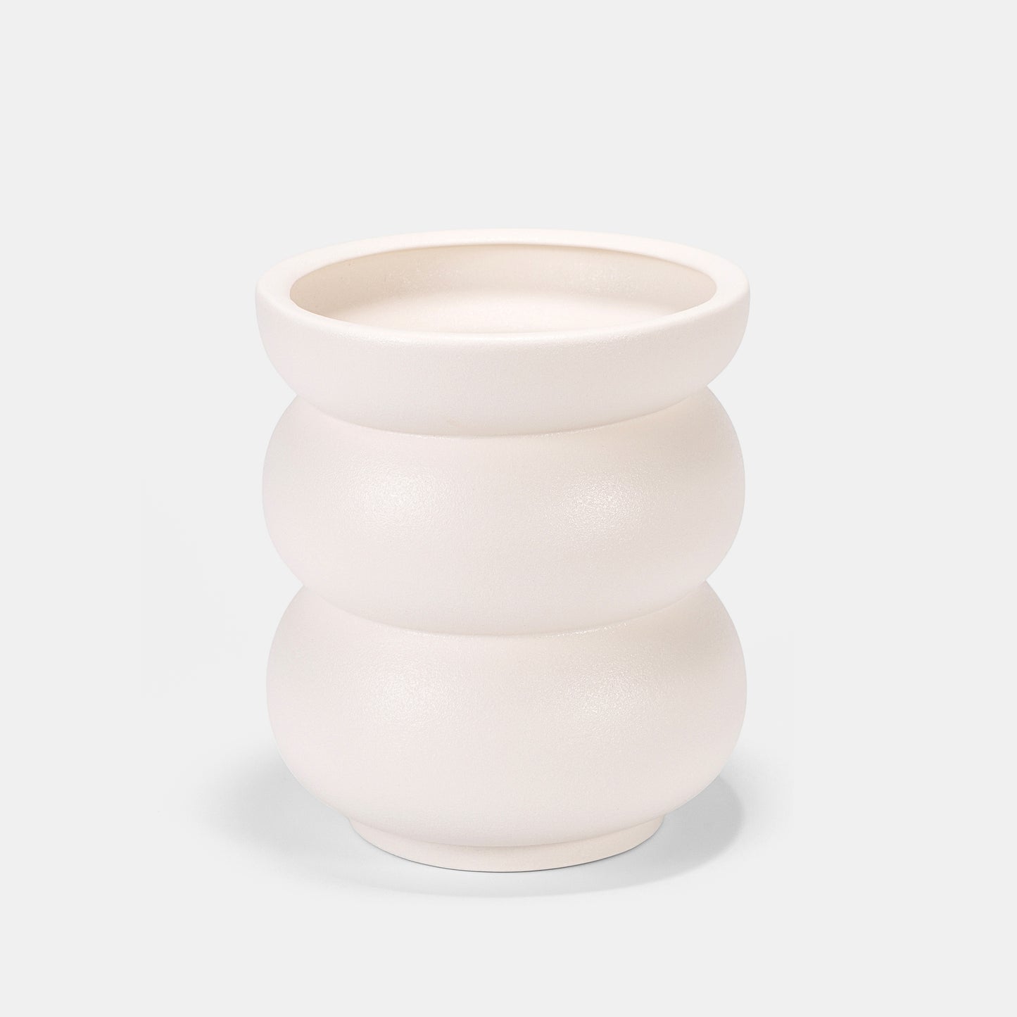Artisanal white ceramic vase features organic, belly-like contours with a tactile matte finish. Holds peonies dramatically or stands solo as sculptural decor. Complements slender bud vases in yin-yang arrangements. Fits boho-chic to farmhouse styles—textured imperfections tell its handmade story. 