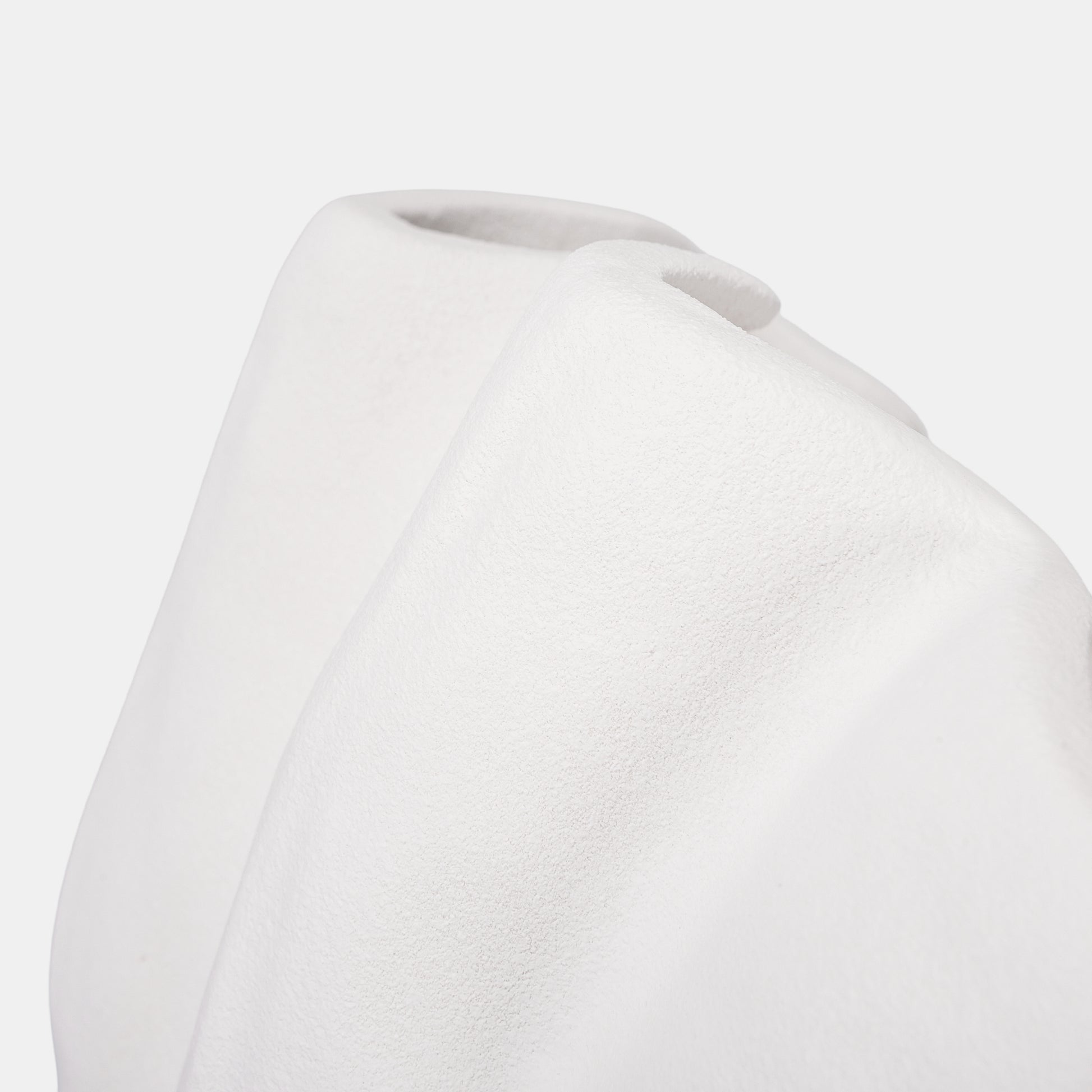 This monumental white ceramic vase blends bold vertical ridges with an undulating rim for sculptural drama. At 22cm tall, its huge vase stature holds grand flower vase arrangements or doubles as a minimalist fruit bowl. Lightweight ceramic ensures easy mobility, while matte white vase texture amplifies stone-inspired elegance. Use textured crevices as bud vases for stems or showcase dried botanicals—seasonal versatility meets gallery-ready design.