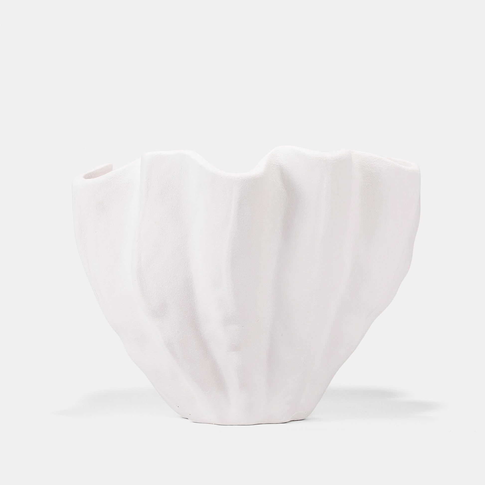 A 22cm white ceramic vase adapts as a fruit bowl, floral anchor, or art piece. Vertical ridges frame winter citrus or summer wildflowers, while the matte white vase ceramic surface casts sculptural shadows. Ideal for bud vases with minimalist stems or grand flower arrangements—effortless elegance redefined. 